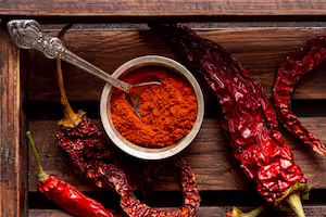 Home cooked spicy dishes including chili con carne and roasted vegetables prepared using hot chili powder seasoning