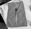 Simple fork and kitchen towel icon representing home cooking, food preparation, and spice based recipes